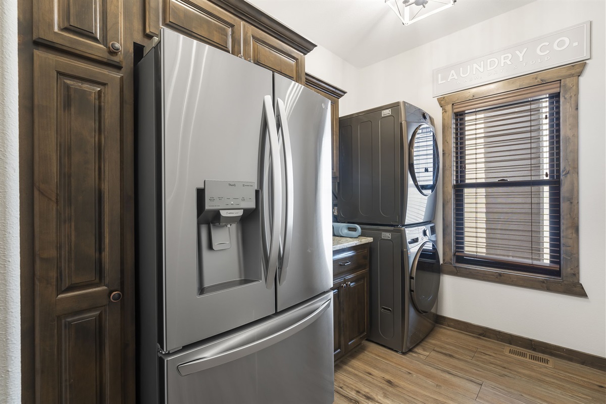 Main floor laundry and additional full sized fridge just off of the kitchen