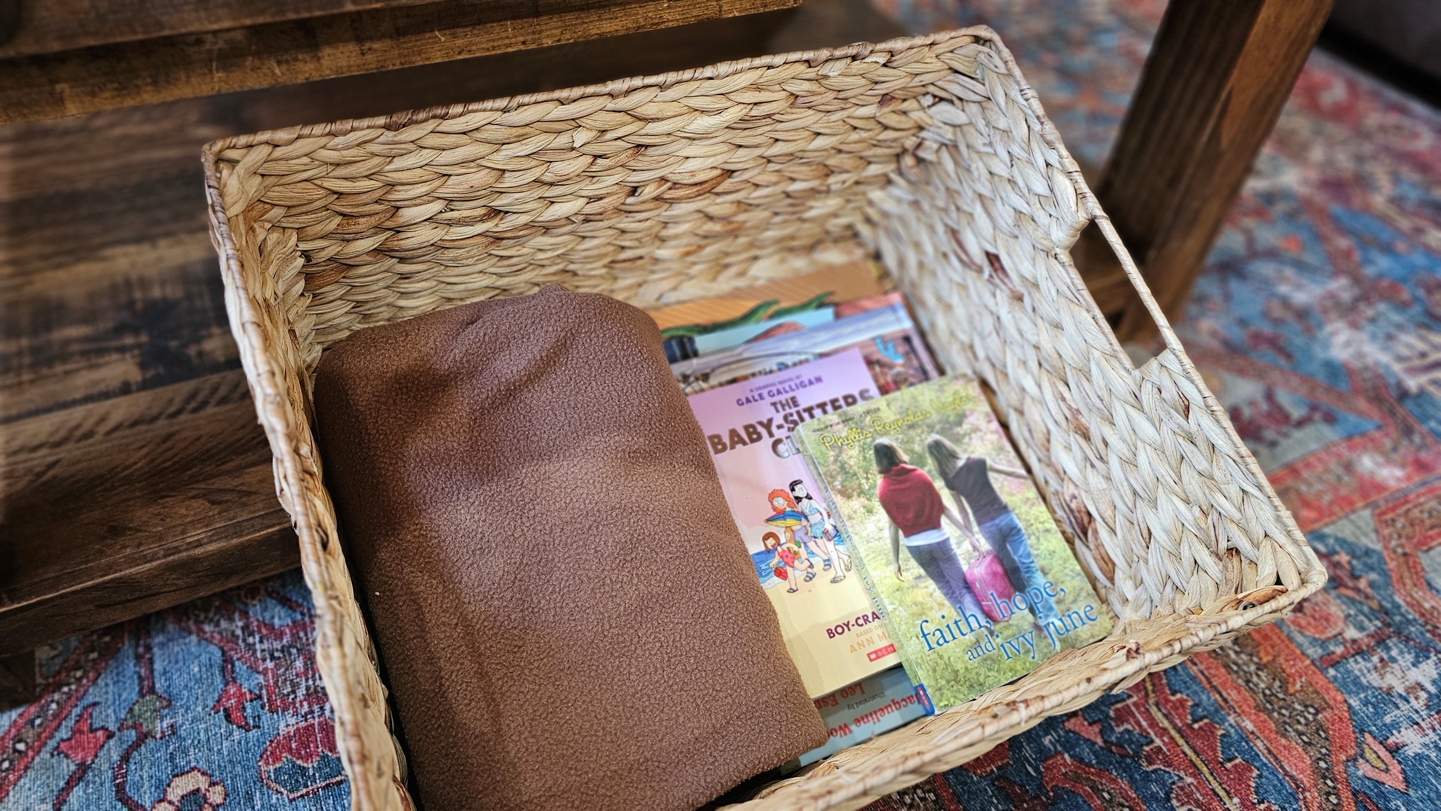 Books and blankets under the coffee table.