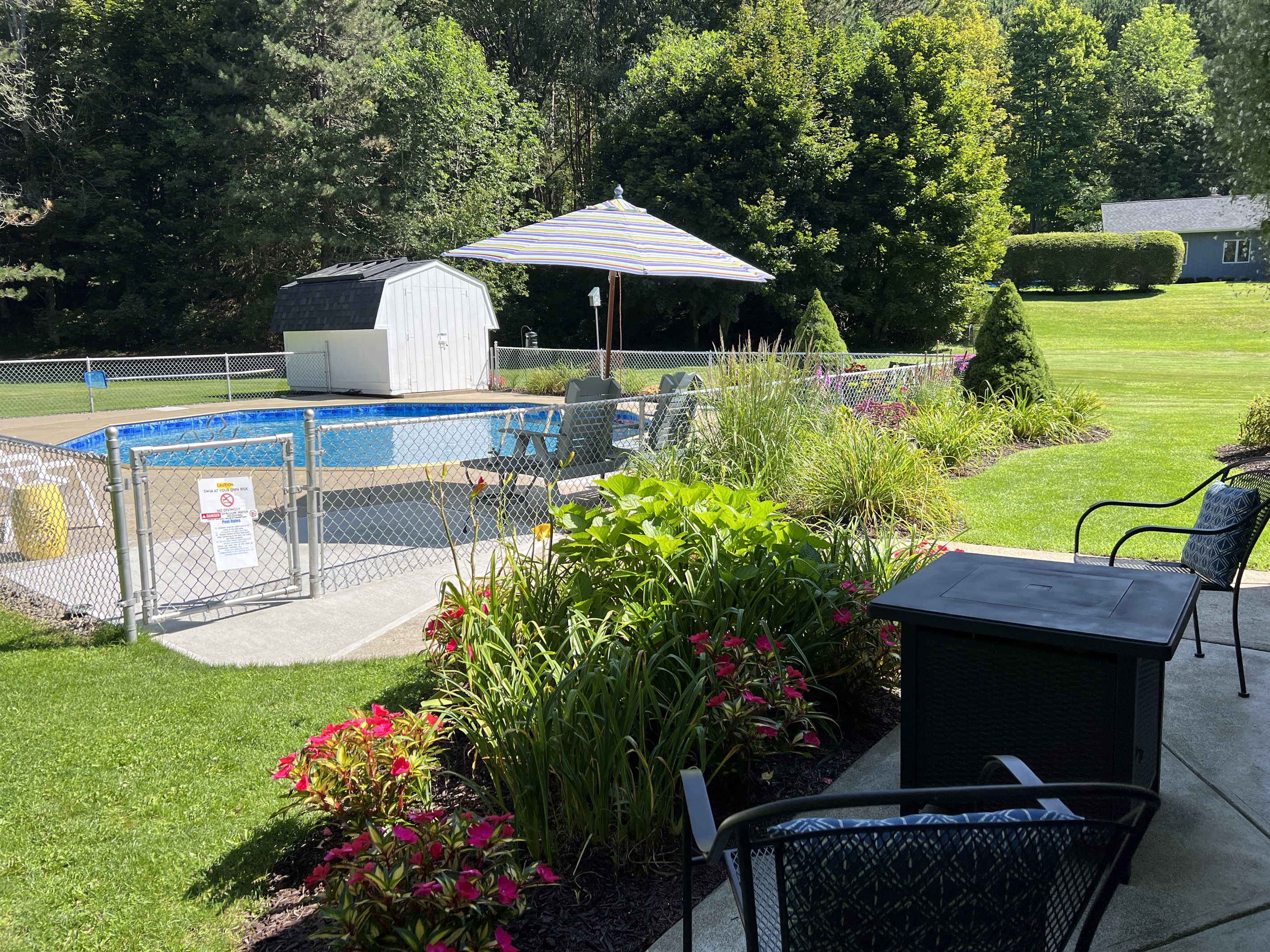 Outdoor patio with gas fire table by pool