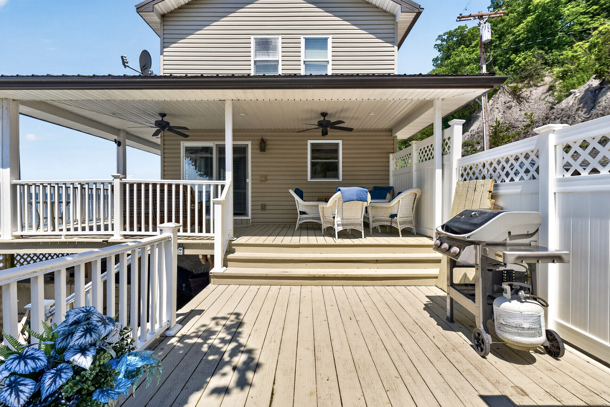 Deck with dining set and gas grill