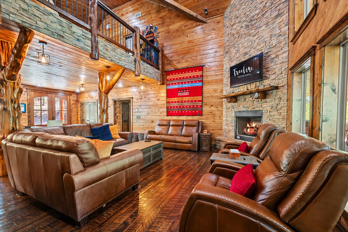 Large windows bring in natural light while giving you a view of the surrounding woods, making the living area feel bright and connected to nature.