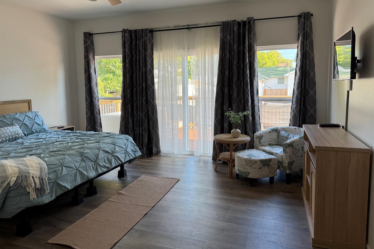 Master Bedroom overlooking furnished upper deck that covers entire length of rear elevation