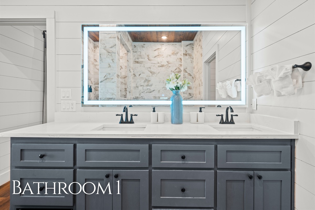 Getting ready is simple in this bright bathroom space, with a modern vanity and plenty of room for everyone&rsquo;s essentials.