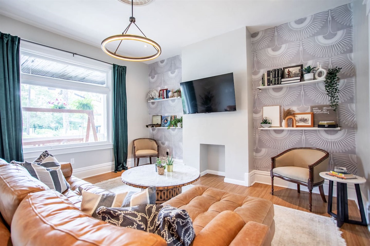 Stylish living room with a cozy ambiance, featuring modern furnishings and a TV, creating the perfect space to relax and unwind.