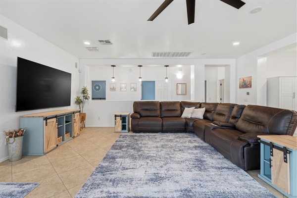 Living Room with Leather Sectional and 85" Smart TV