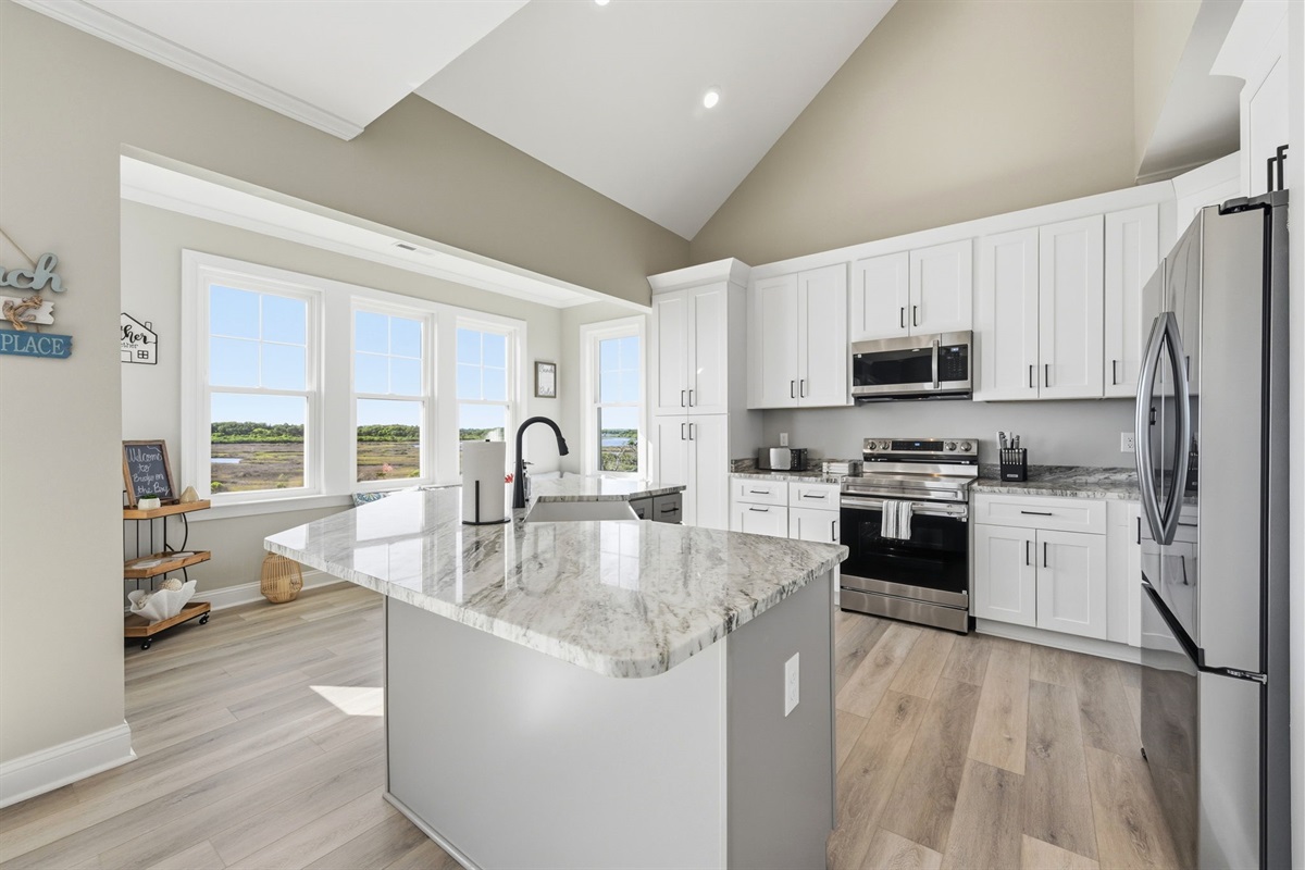 Clean coastal design and a spacious island make this kitchen perfect for group stays