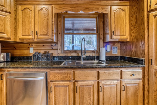Fully stocked kitchen with low tox features like reverse osmosis water filter under the kitchen sink and attached to the fridge water, stainless steel pots and pans, glass and ceramic bakeware, stainless and silicone cooking utensils, and more!