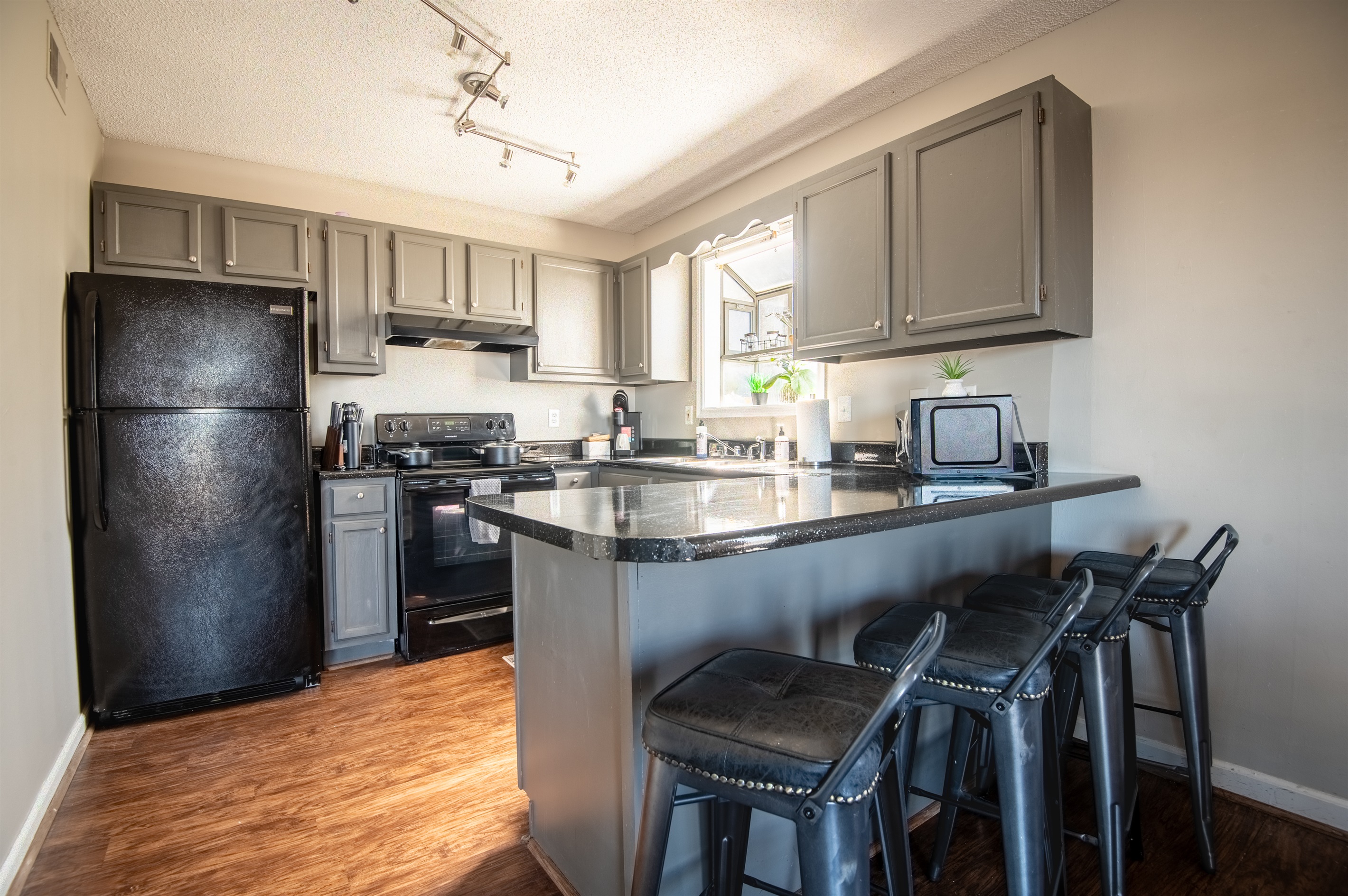 Unit F has a bright kitchen with warm accents to ensure your time there is as relaxing as possible. The kitchen is also completely stocked with anything you might need to whip up your favorite dish!
