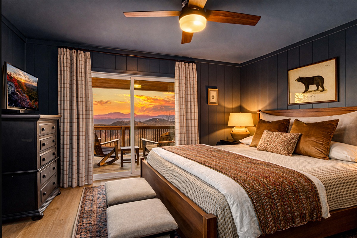 The Bear Room features a plush king bed, rich slate-toned walls and trim, and a warm, lodge-style feel that makes this space especially cozy and inviting. Private ensuite bath and sliding doors to the covered porch. 