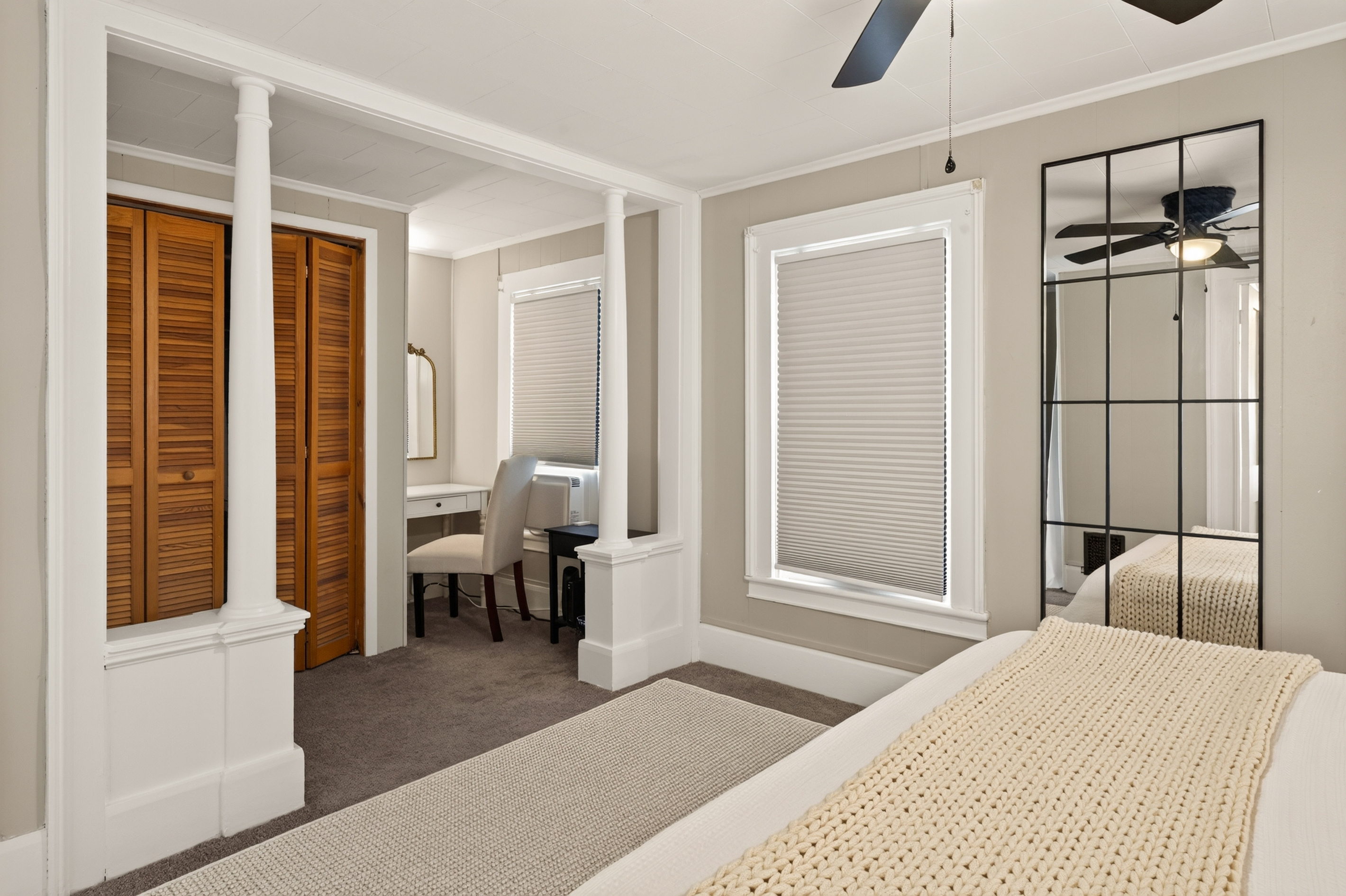 Bedroom with ceiling fan and two windows
