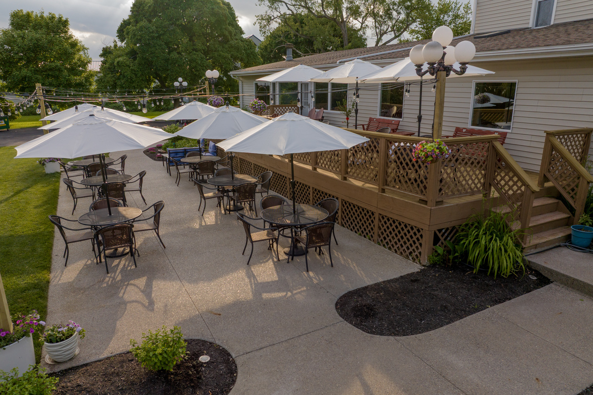 The Victorian Inn's grounds offer a relaxing retreat with flower gardens, shaded seating areas, a wedding pergola, romantic swing, and inviting outdoor gathering spaces