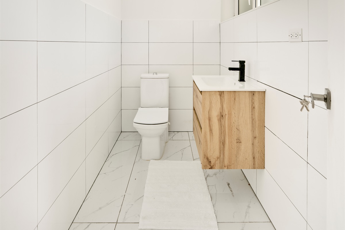 First‑Floor Half Bath Featuring Sleek Vanity & Black Fixtures