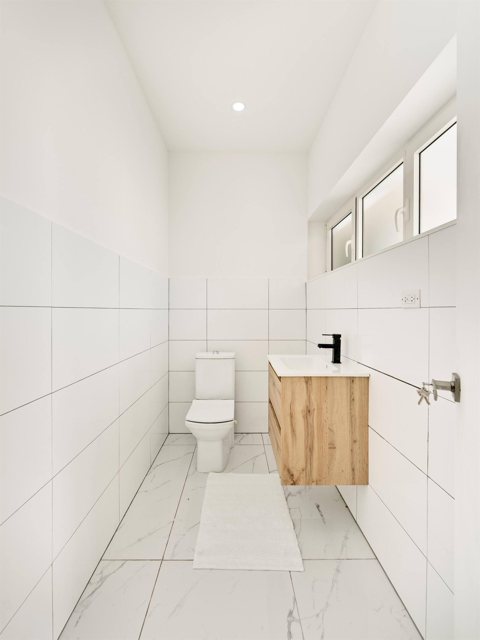 First‑Floor Half Bath Featuring Sleek Vanity & Black Fixtures