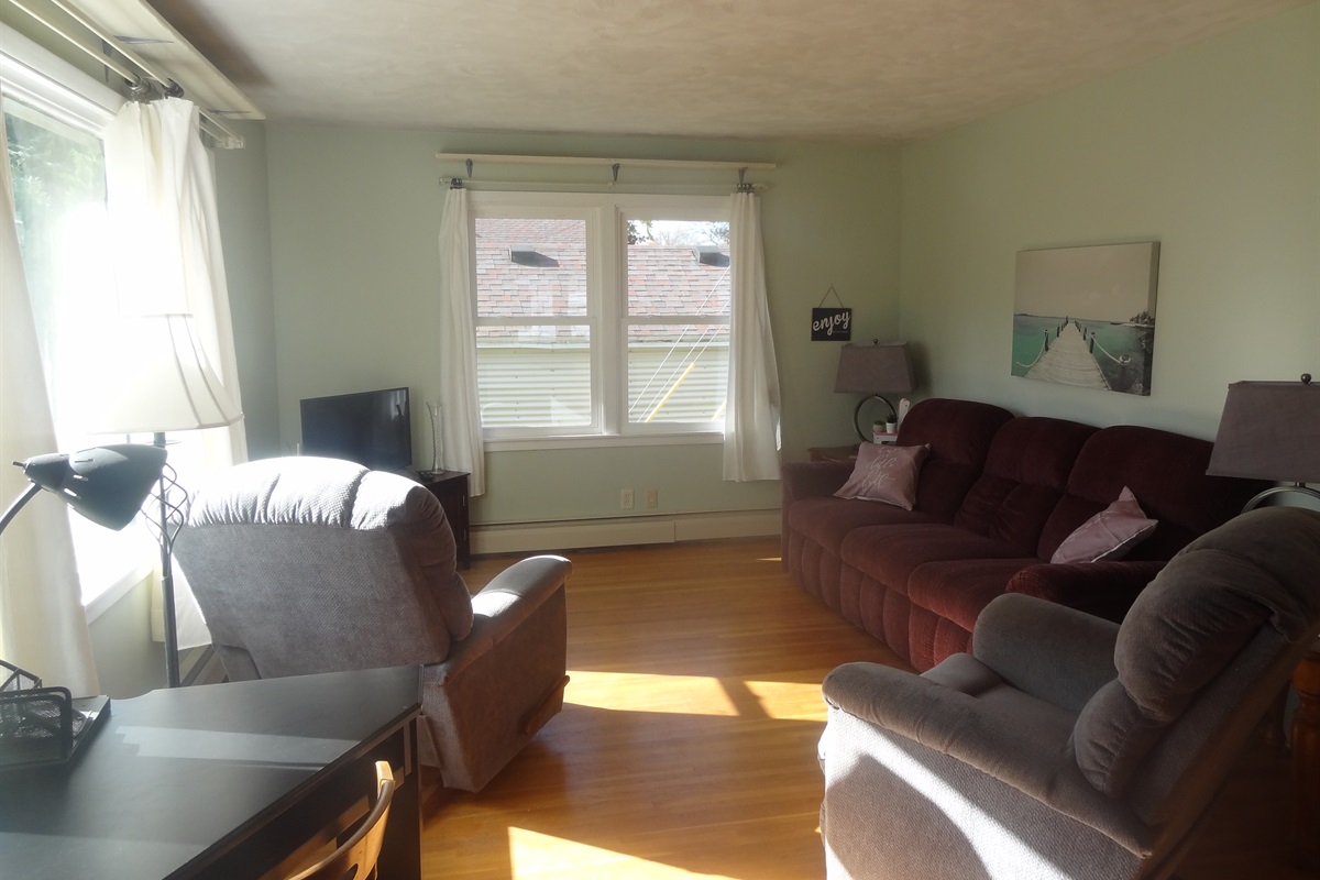 Full size couch, 2 recliners, Roku smart TV, laptop work space