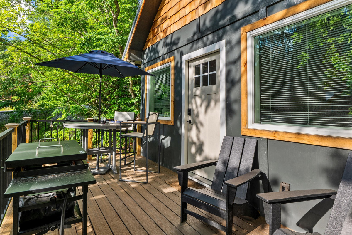 Deck with Blackstone Grill, cafe lights, bistro table and sitting chairs
