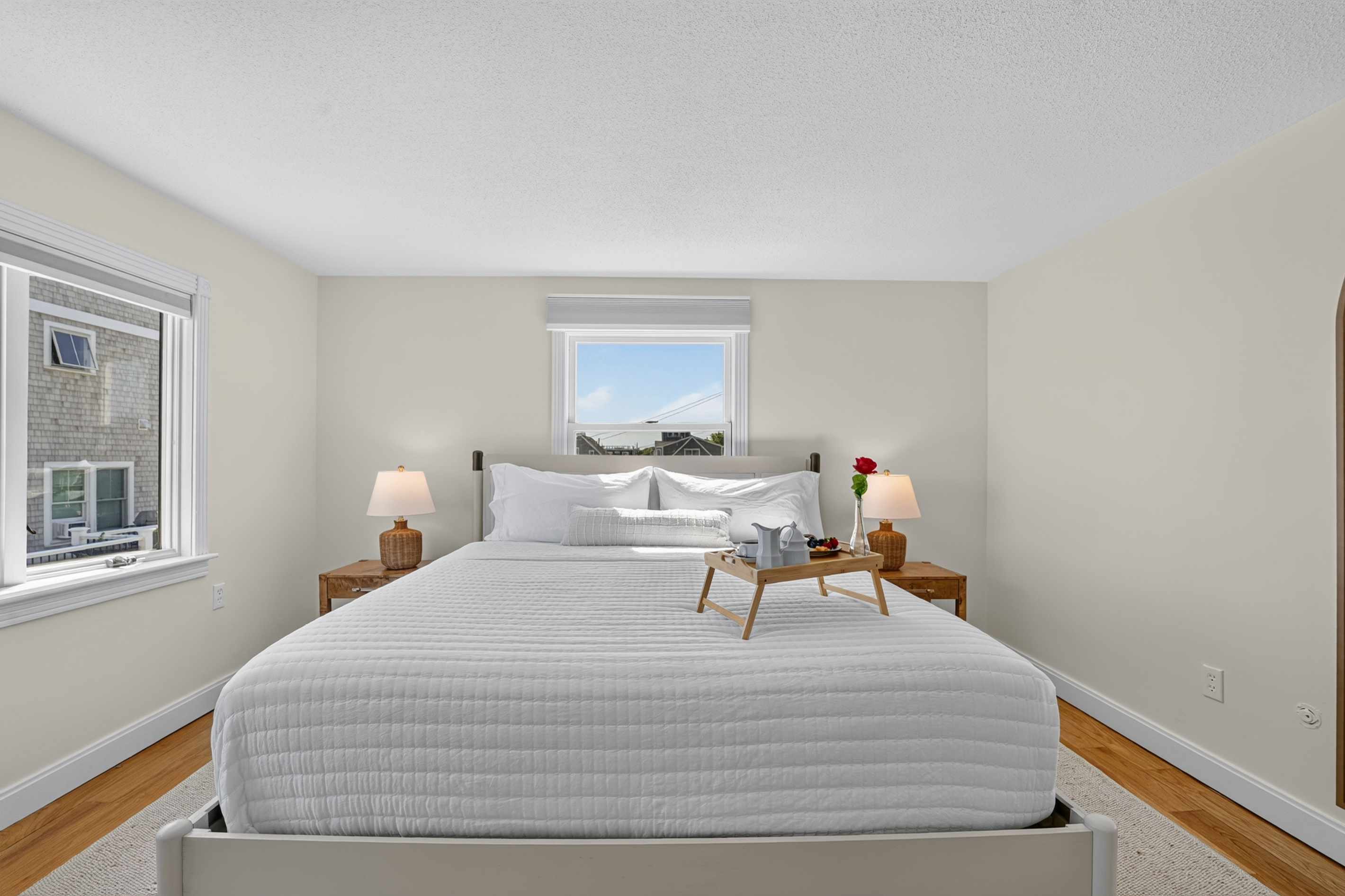 Rest easy in this bright bedroom with windows bringing in plenty of natural light.
