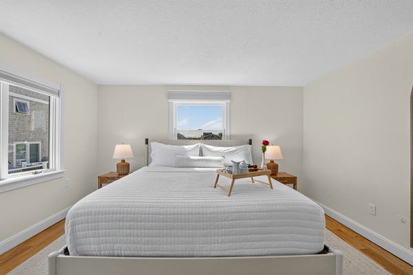 Rest easy in this bright bedroom with windows bringing in plenty of natural light.