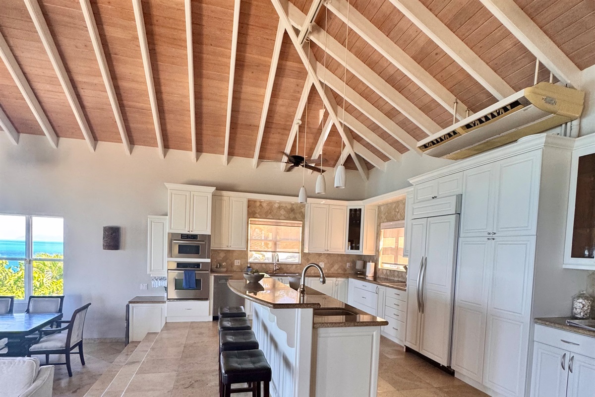 Spacious Kitchen with large island and bar sink, beverage fridge and ice maker. 