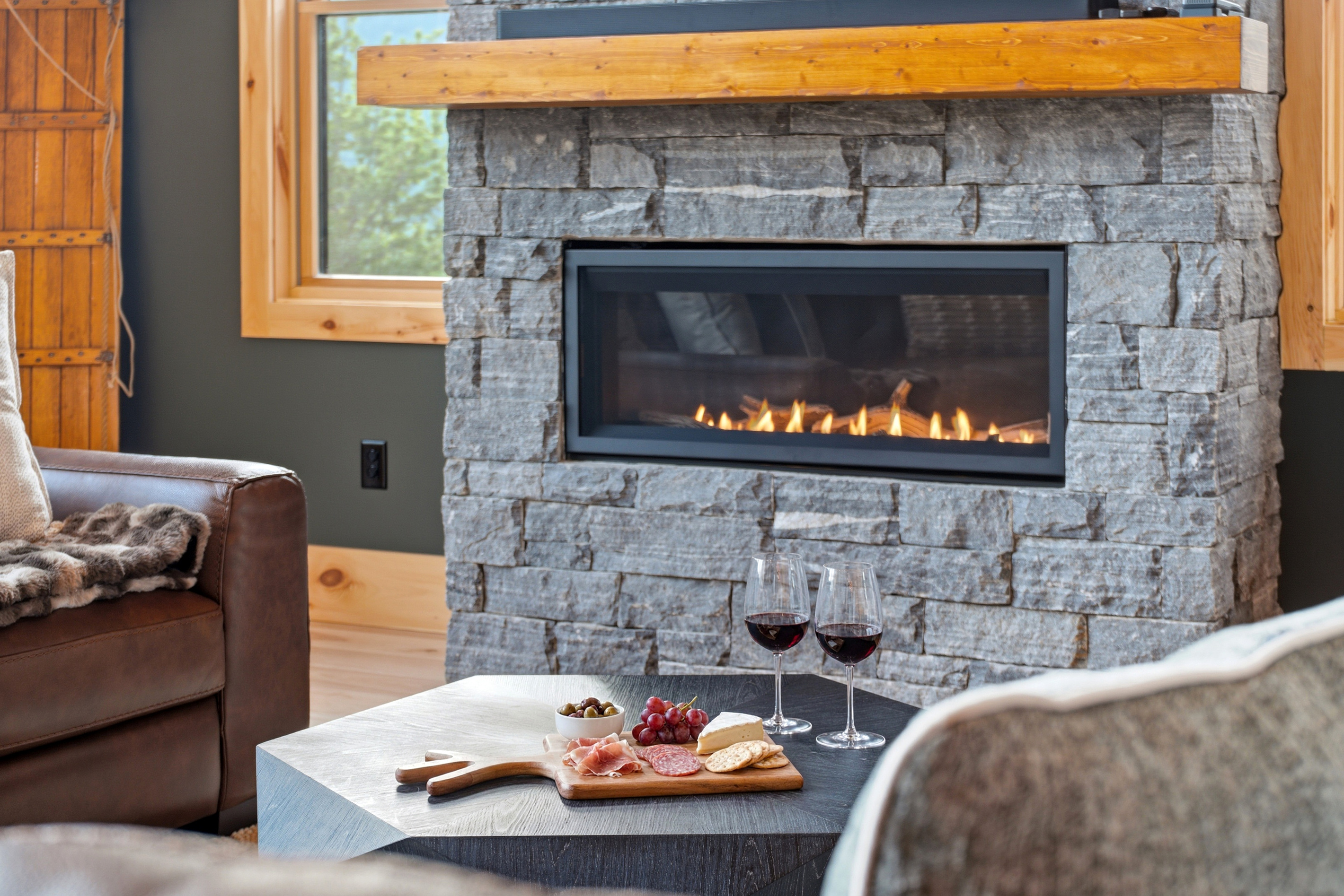 Cozy up beside the stone fireplace—the perfect spot for relaxing after a day of mountain adventures.