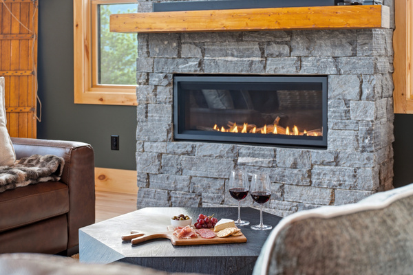 Cozy up beside the stone fireplace—the perfect spot for relaxing after a day of mountain adventures.