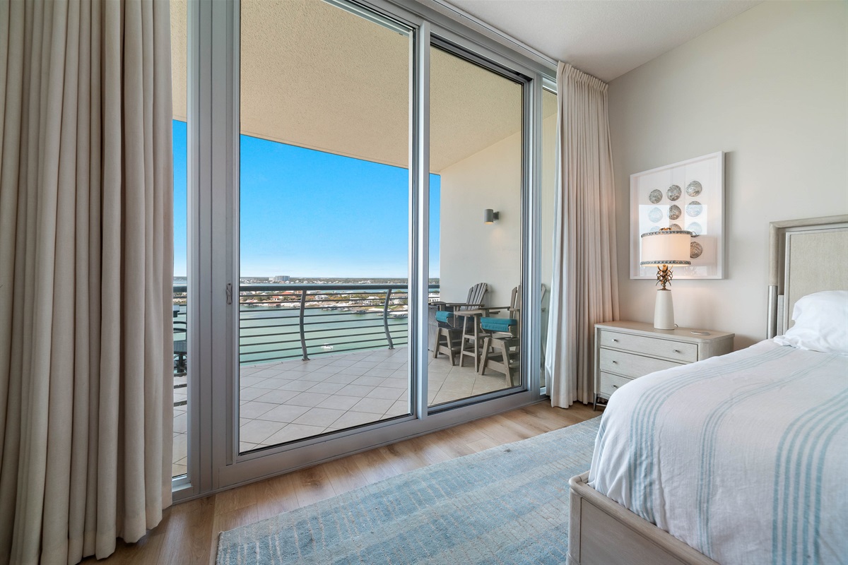 Enjoy a restful night's sleep with panoramic coastal views from this beautifully designed primary bedroom. The seamless transition to the balcony allows you to fully immerse yourself in the beauty of Ole River.