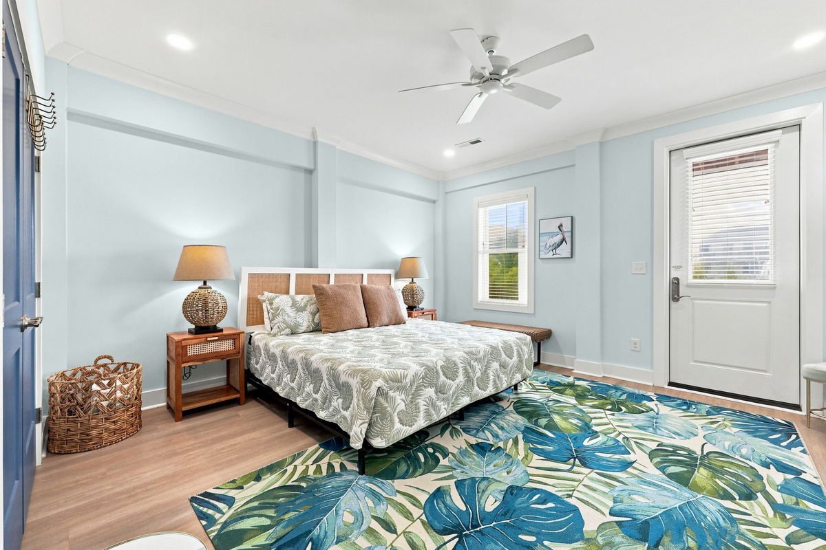 Comfortable king suite with elegant furnishings, a large area rug, and a private entrance for added convenience