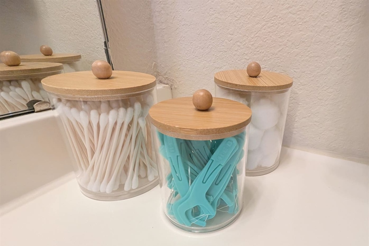 Cotton swabs, cotton balls, and tooth flosser provided for guest use. 