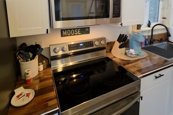 Kitchen includes an electric range, refrigerator, and Keurig.