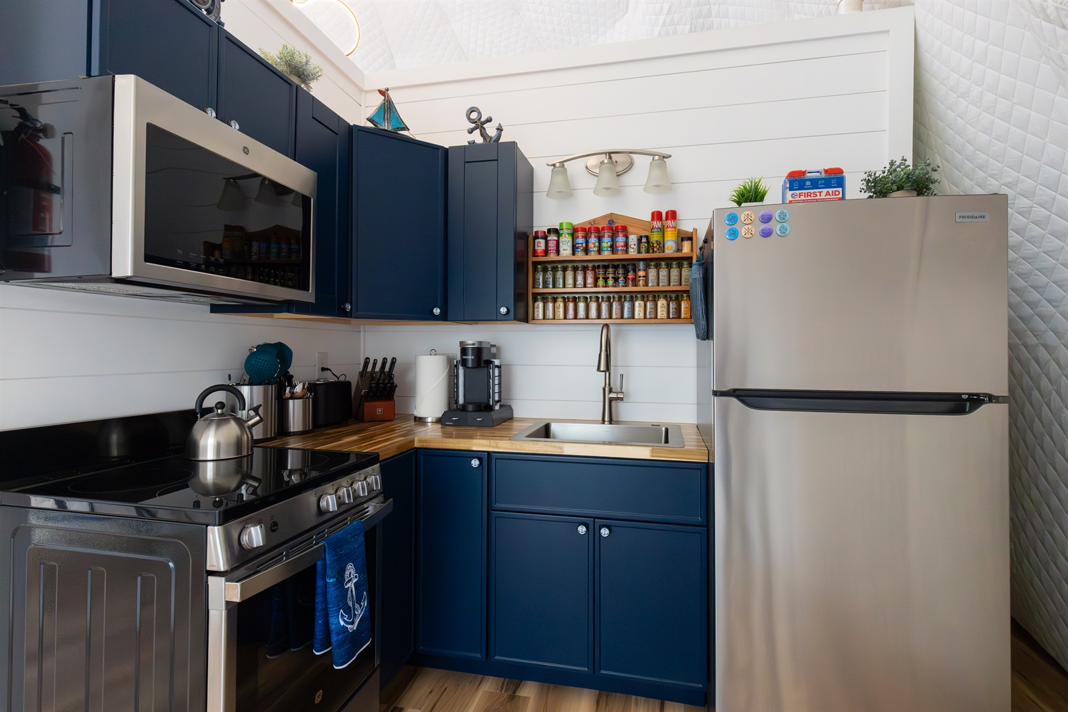 Fully stocked nautical kitchen with full-size appliances, spices, cookware, and everything you need for effortless lakeside meals