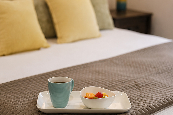 Coffee and fresh fruit on the bed set the tone for an easy, unhurried morning before the day begins.