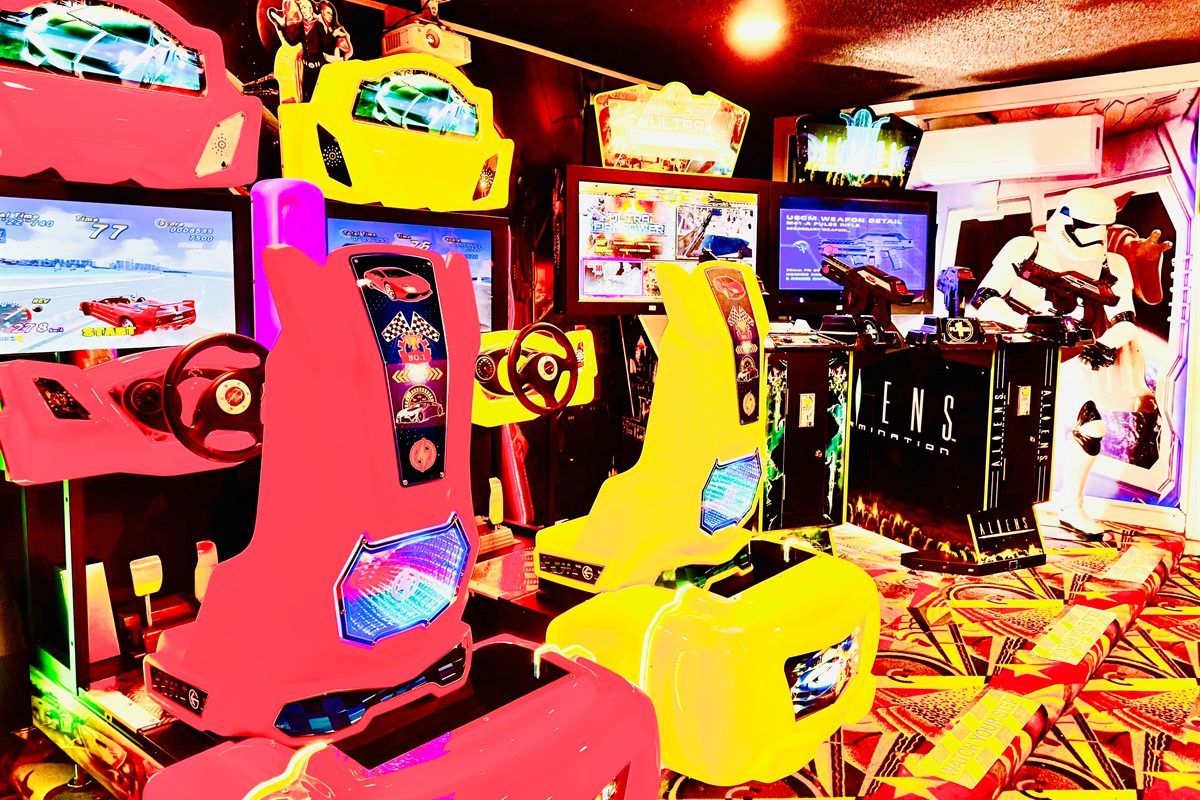 Professional arcade featuring Outrun 2, Aliens, Ultra Fire Power and a life size storm trooper.