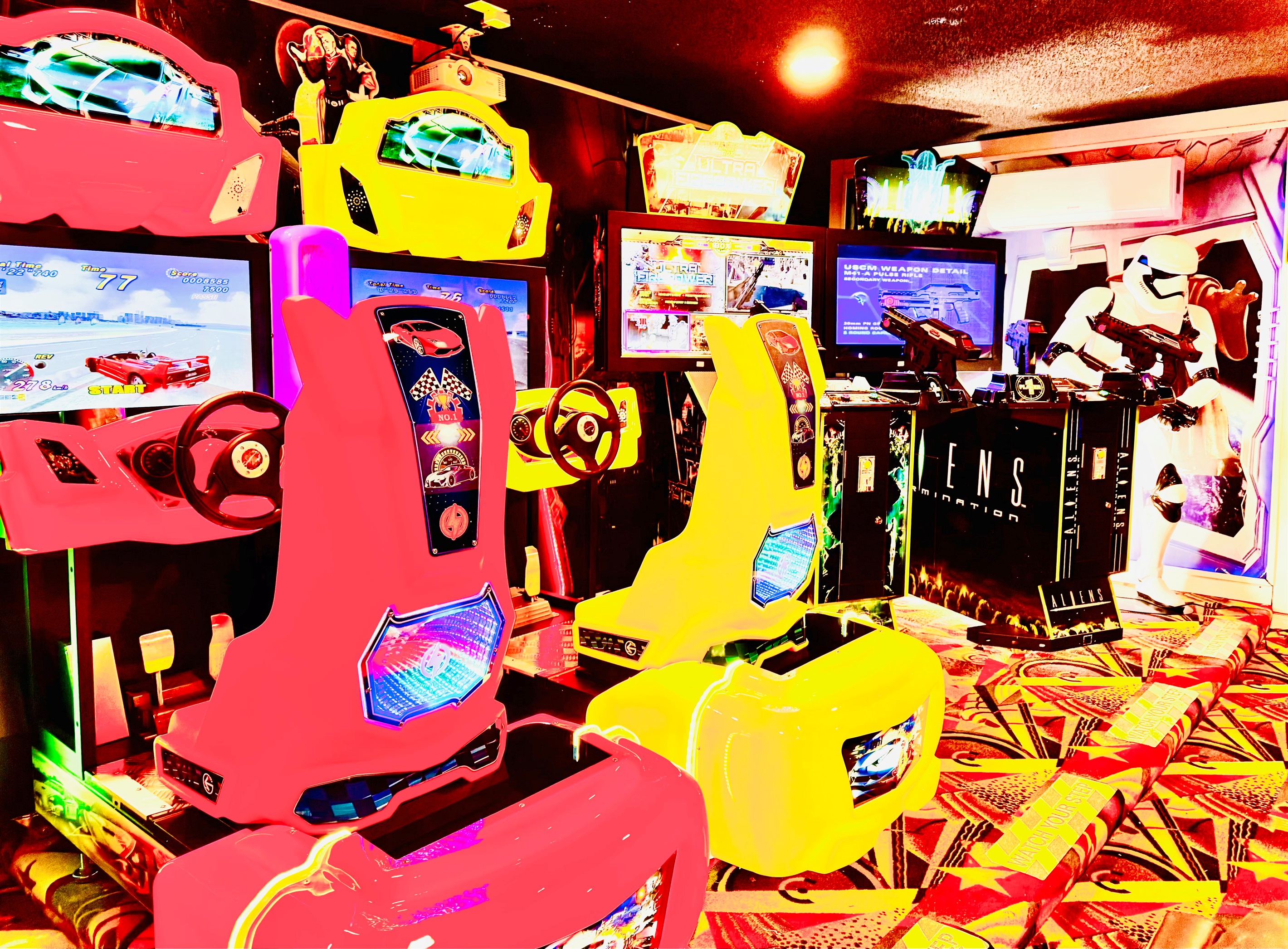 Professional arcade featuring Outrun 2, Aliens, Ultra Fire Power and a life size storm trooper.