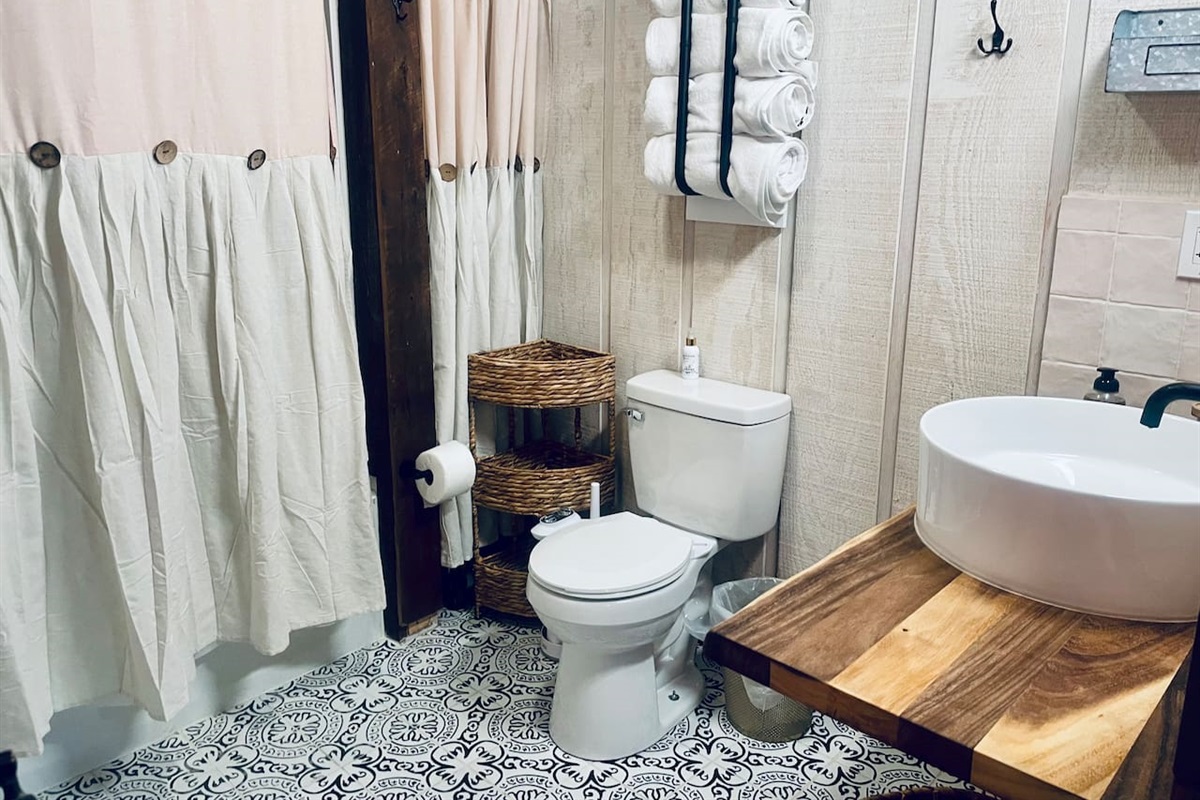 Tub/shower combination, toilet with bidet, beautiful live edge bathroom vanity with oversized vessel sink make this 8’X8’ bathroom the exception to the rule in a tiny home.  There’s nothing small about this bathroom. 