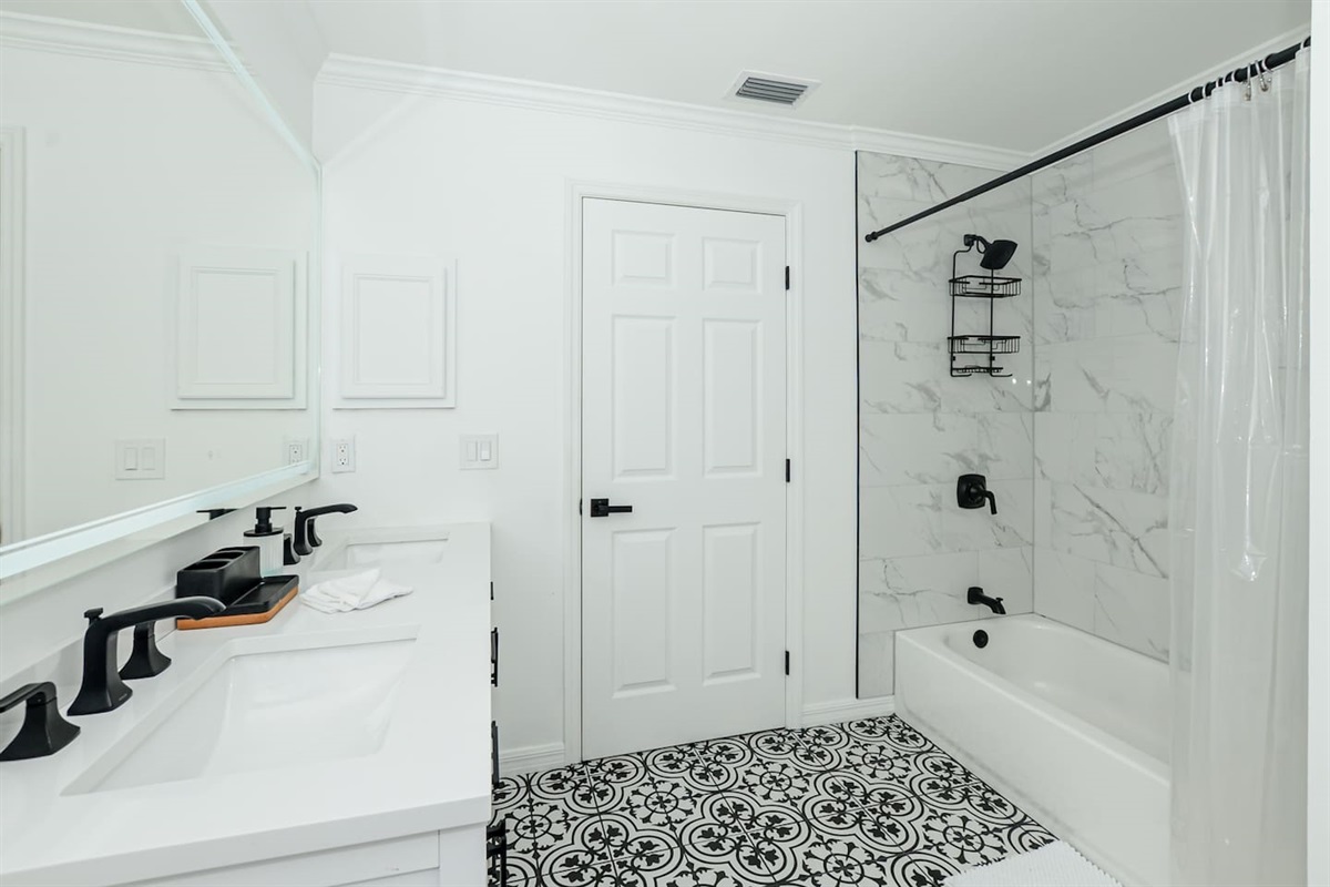 Spacious full bathroom featuring a relaxing tub, offering comfort and convenience.
