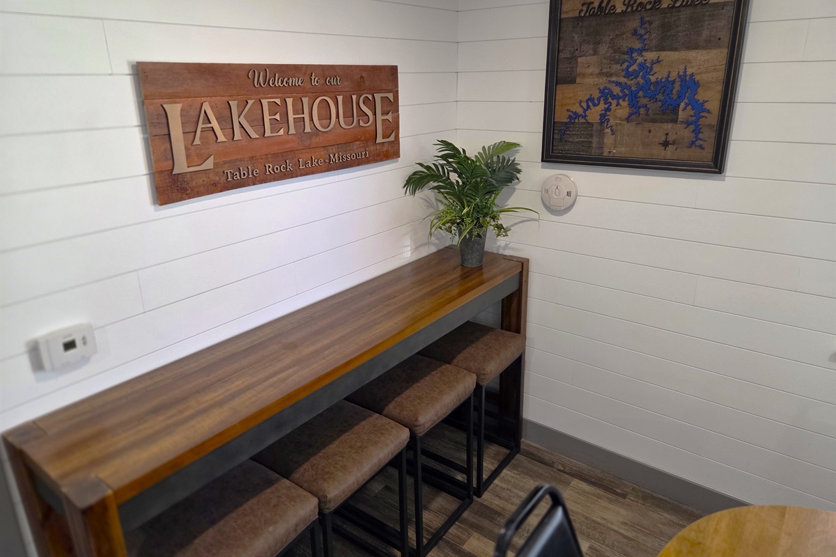The dining bar is great for eating or storage while enjoying the Lake Cabin and Table Rock Lake wall art!