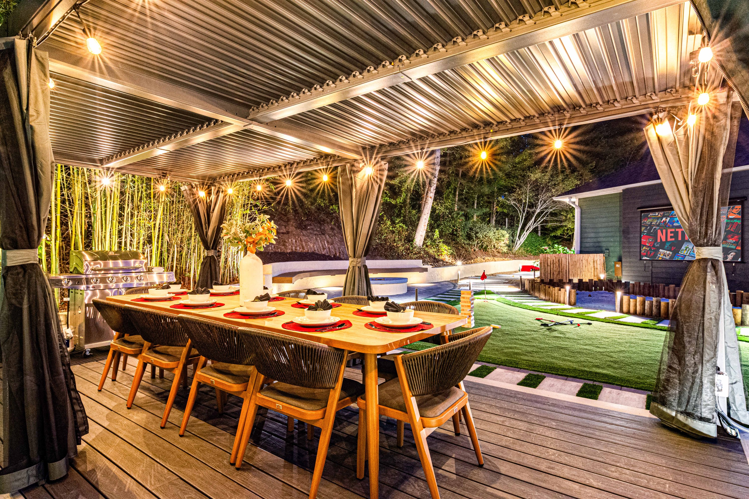 Dine al fresco under sparkling lights in this cozy outdoor haven, complete with a putting green, BBQ grill, and all the vibes for an unforgettable evening.