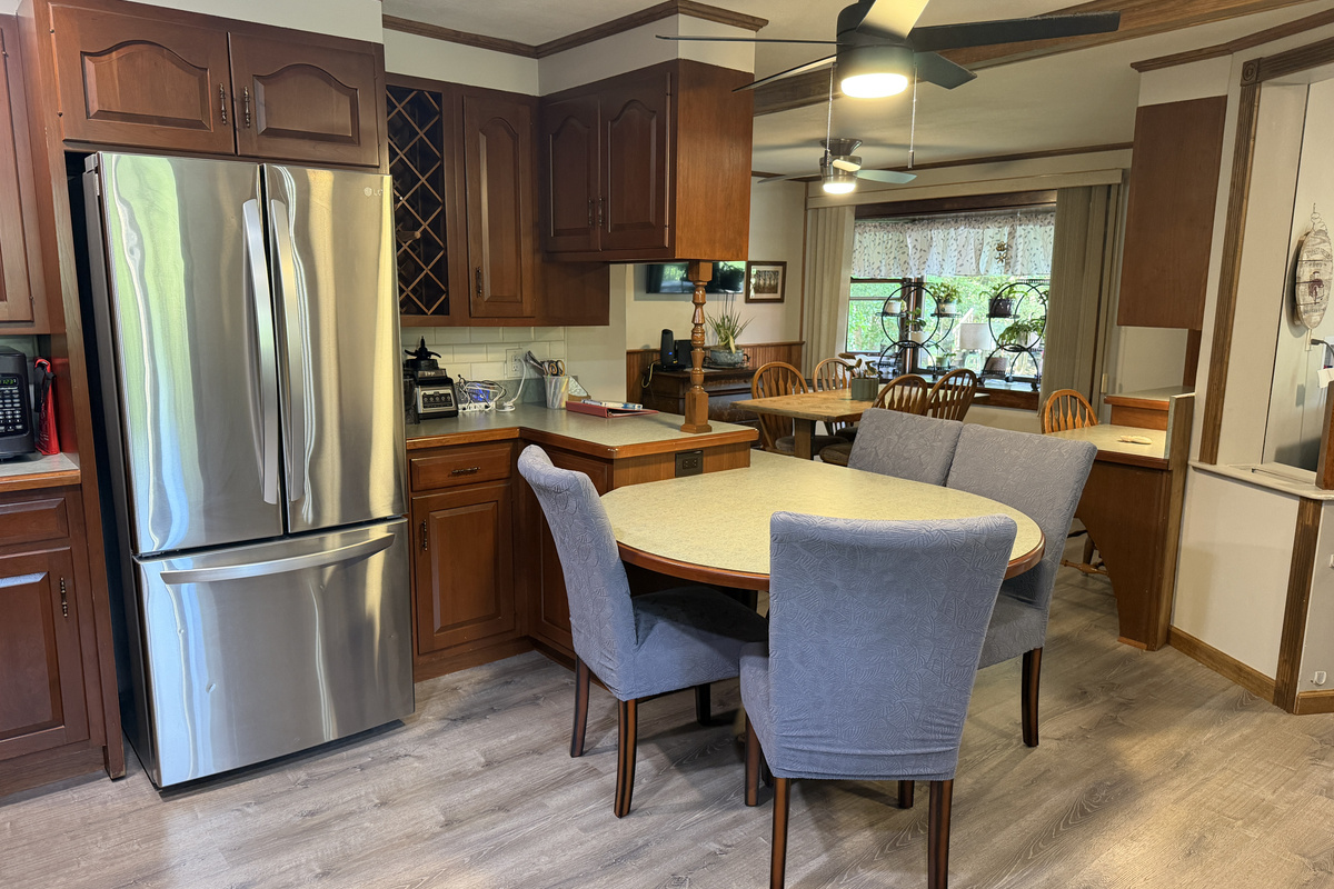 Kitchen with breakfast nook and dining area beyond