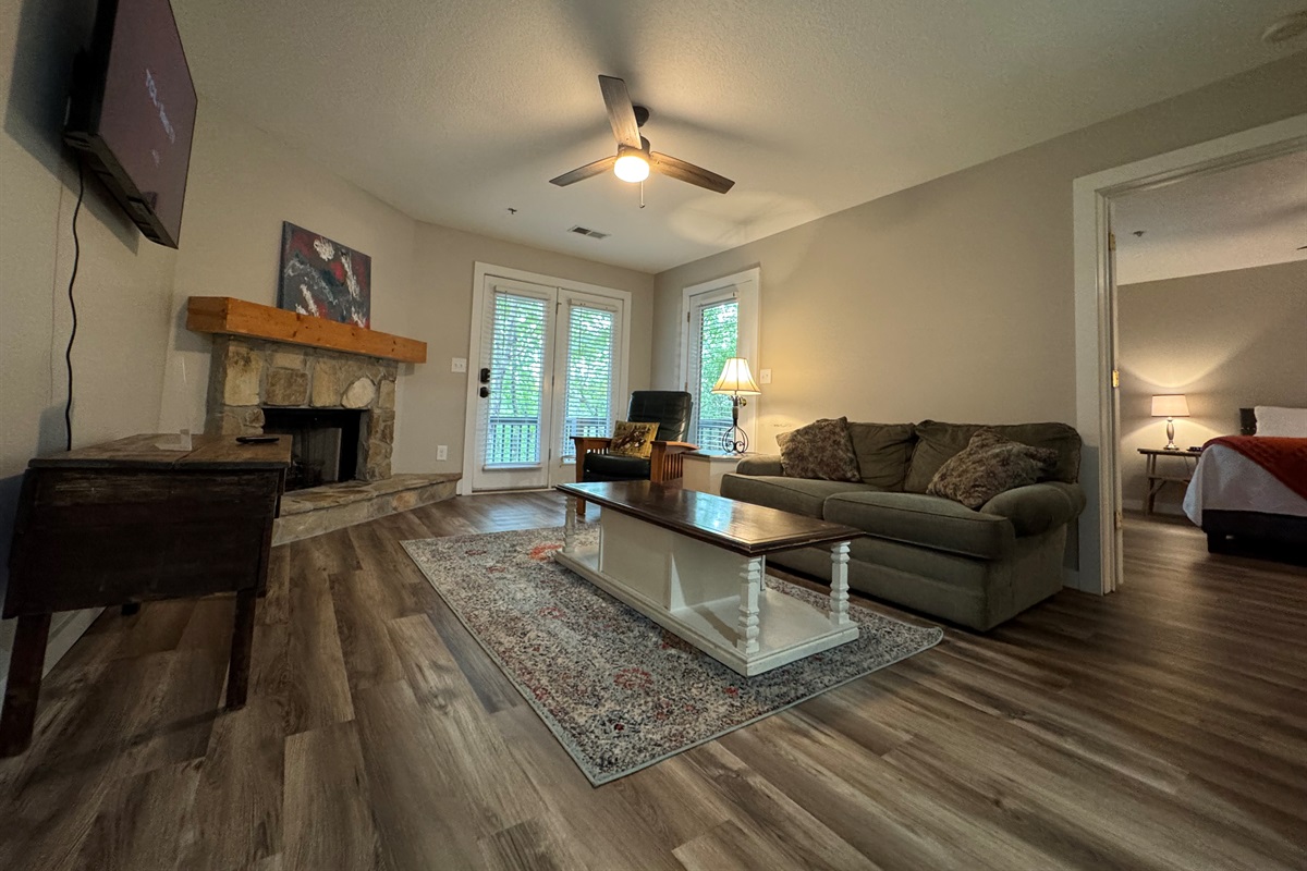 🛋️ Relax in the living room with a gas log fireplace, Roku TV, and open flow into the bedroom.