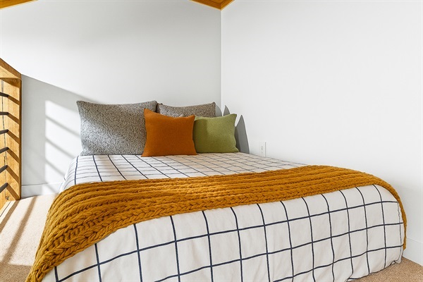 This tucked-away double bed offers a quiet and restful spot to recharge.