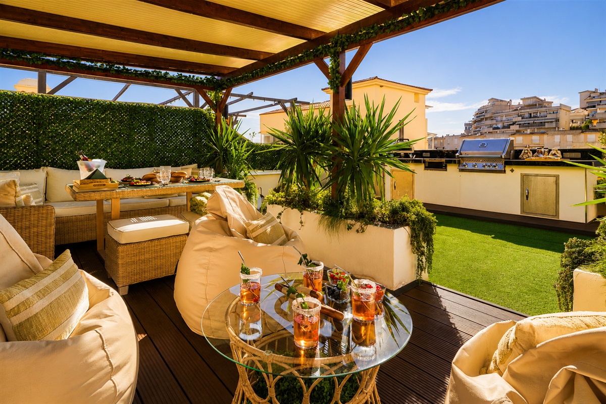 Relax beneath the covered pergola with cozy seating, fireplace, and dining area. Perfect for long evenings, romantic dinners, or movie nights on the outdoor TV under soft ambient lights.