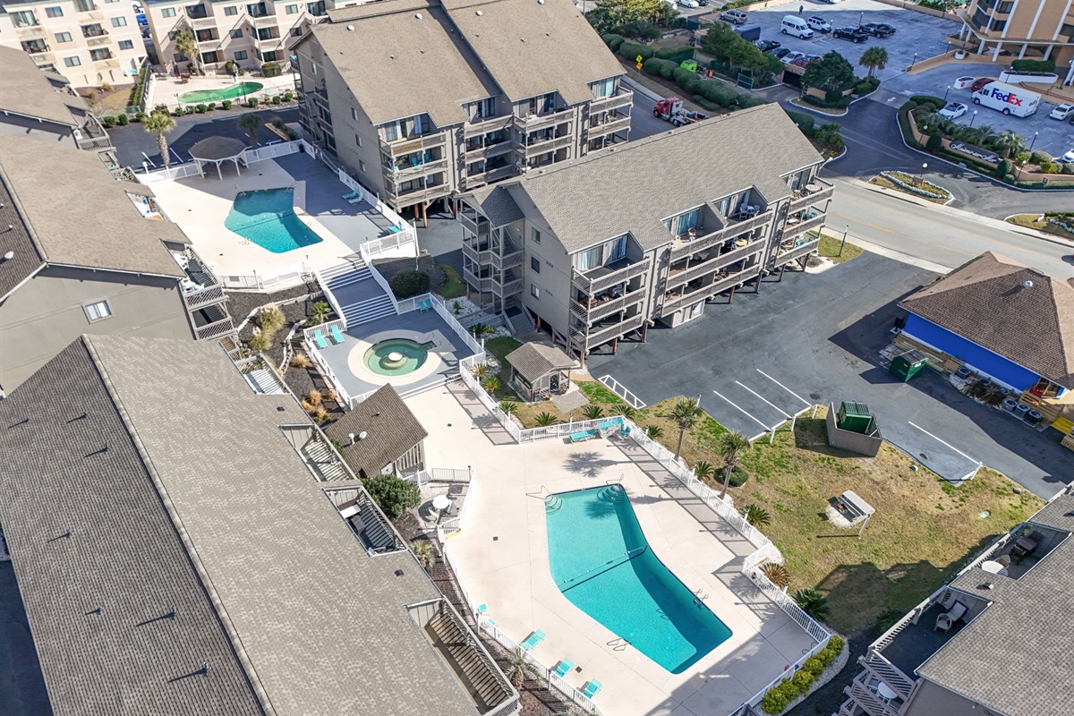 View of two pools & hot tub with oceanview, walk to Flip Flops Bar & Grill and other area resturaunts.