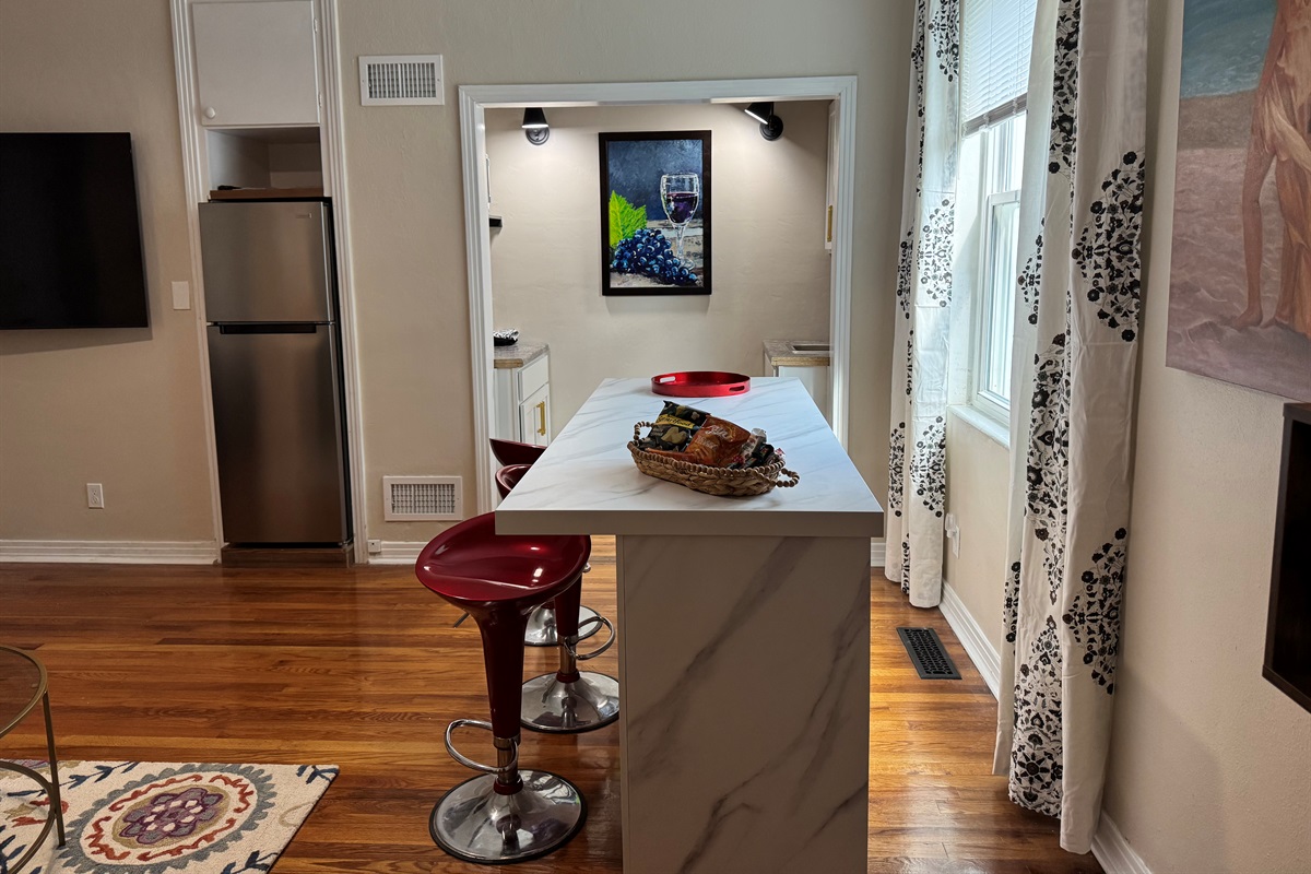 In the living room looking towards the kitchenette and island.