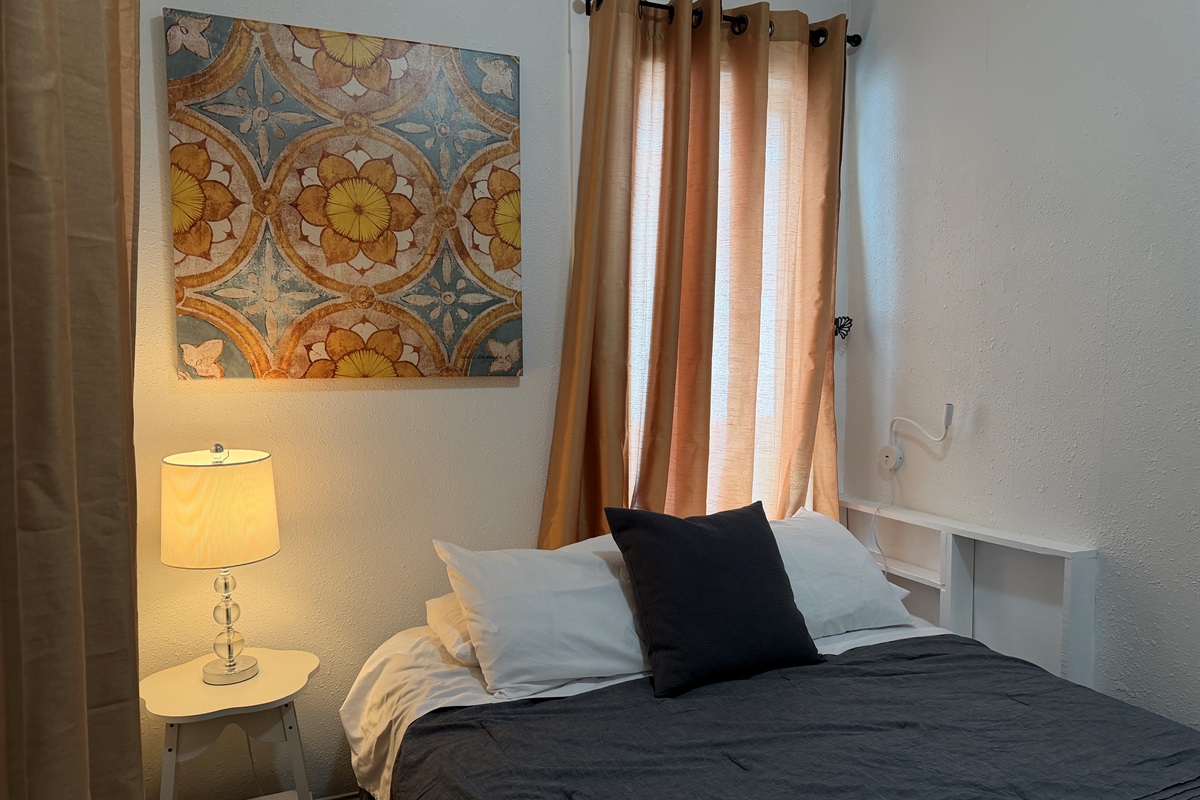 Enjoy the reading lamps and quiet comfort of this queen bedroom.