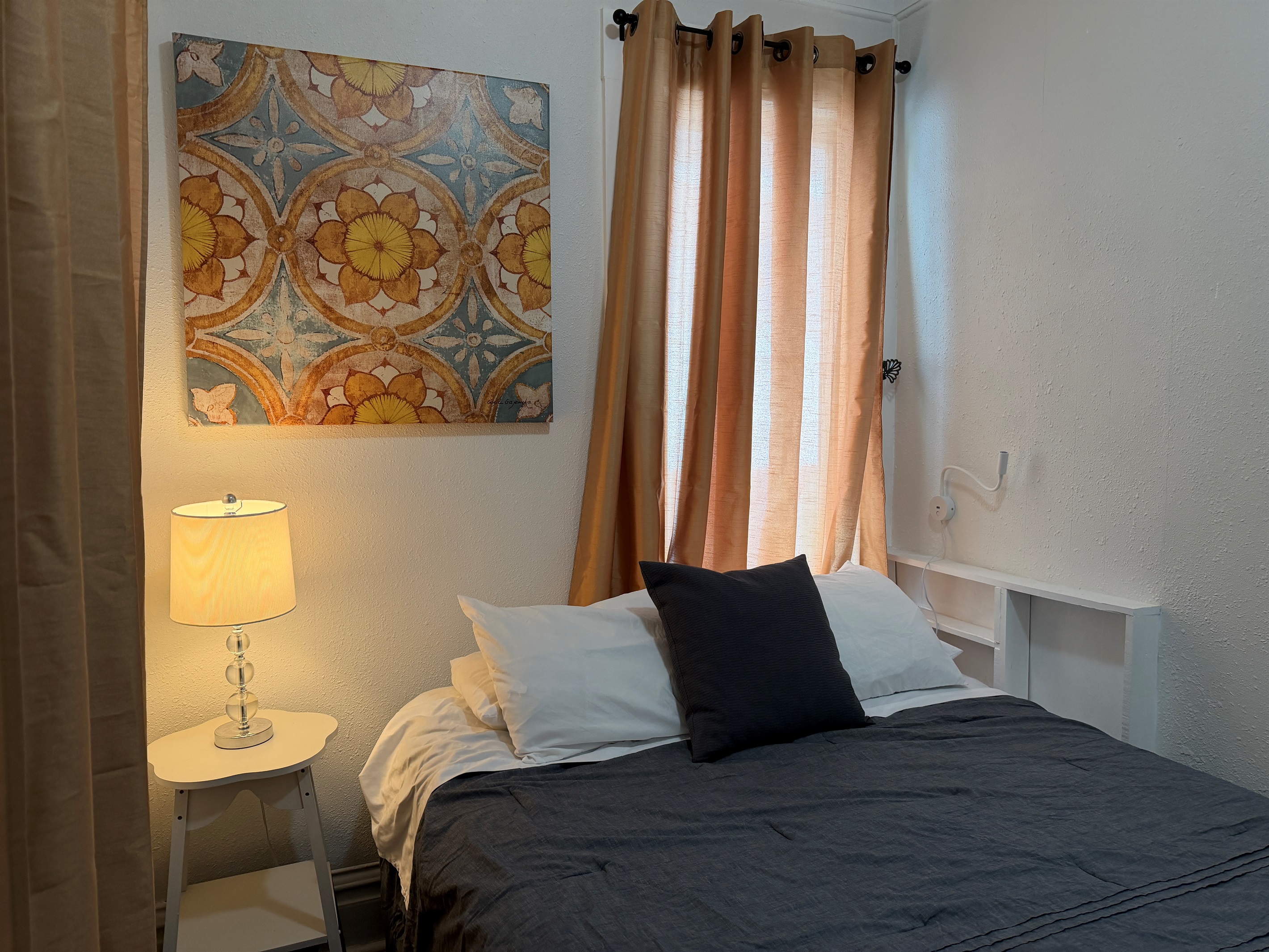 Enjoy the reading lamps and quiet comfort of this queen bedroom.