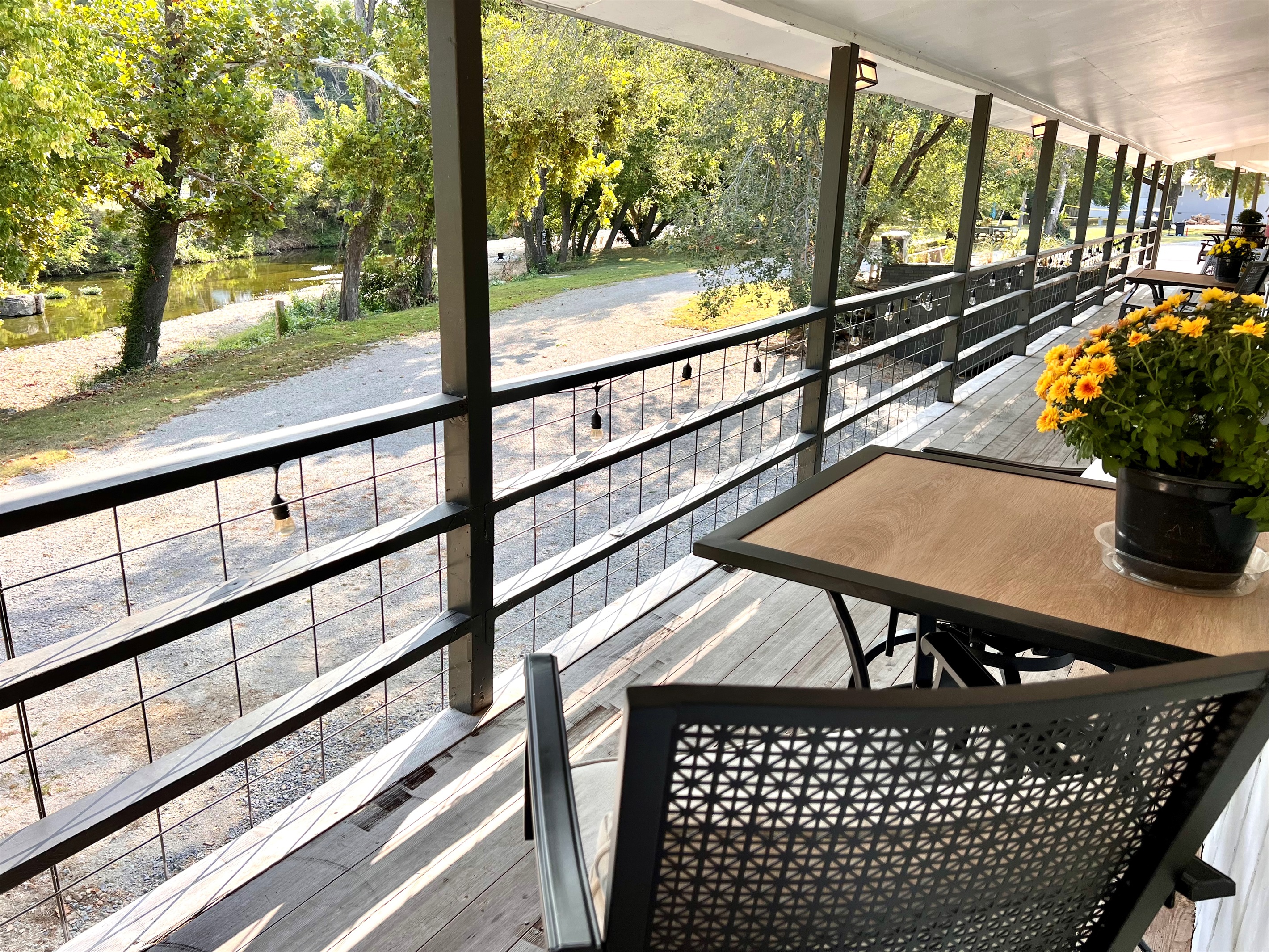 Cozy outdoor seating outside your door with a creek view.