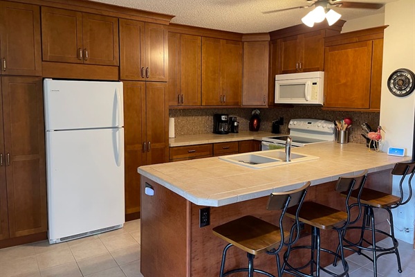 Fully equipped kitchen with ample counter space and seating — everything you need to cook and dine in.