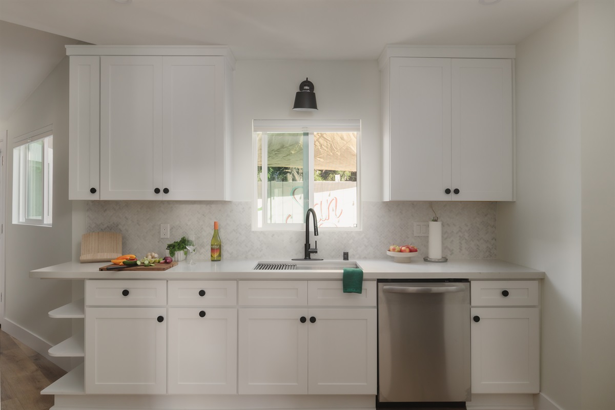 With natural light, sleek finishes, and a view of the backyard mural, this bright kitchen makes everything from breakfast to charcuterie feel a little more special.