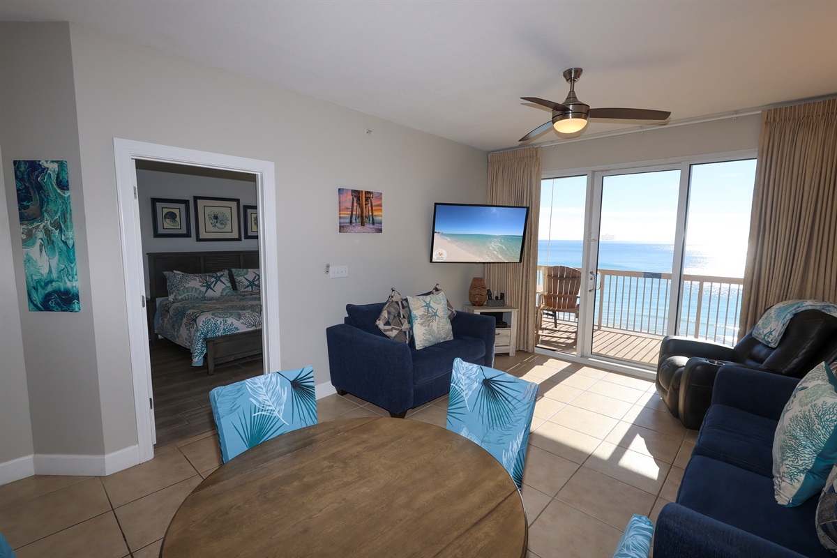 Relax after the beach with family or friends on the comfy queen sleeper sofa — Smart TV and bright coastal décor included