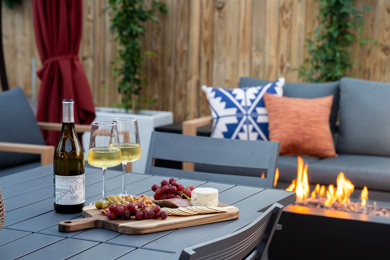An evening of good vibes - wine from our local winery, a charcuterie board, and the cozy warmth of the fire setting the tone for a chill night.