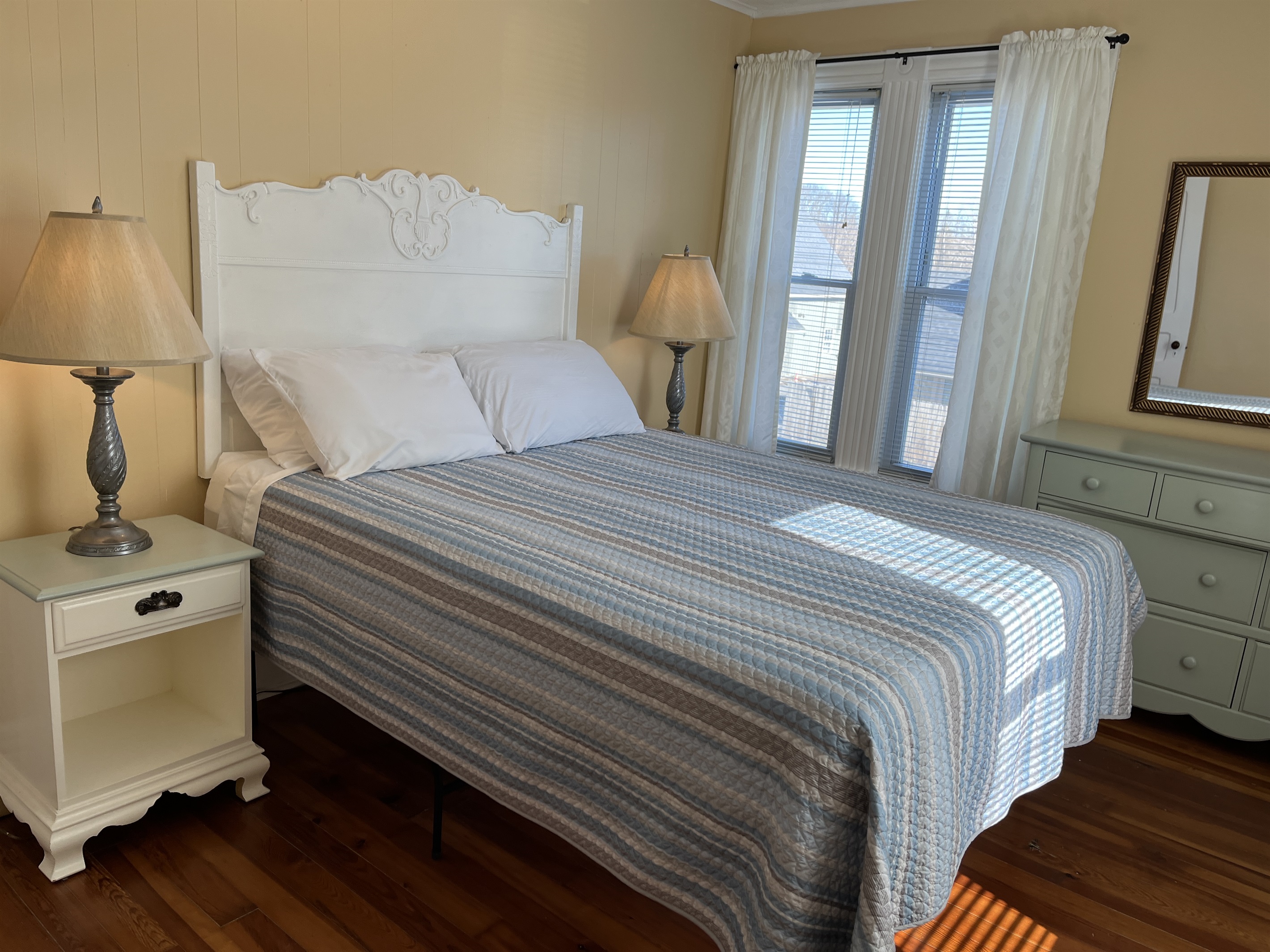 Cooperstown Cottage 2nd floor primary bedroom with queen bed and smart TV.